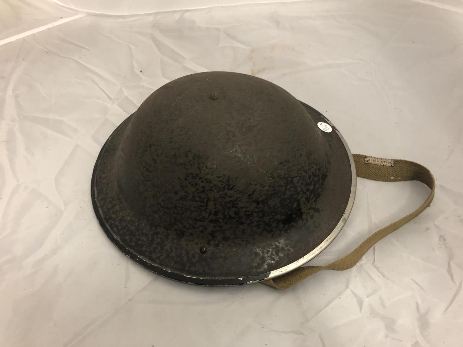 A WWII BLACK PAINTED MILITARY HELMET