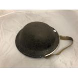 A WWII BLACK PAINTED MILITARY HELMET