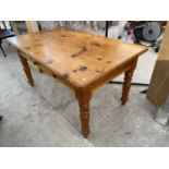 A RECTANGULAR PINE DINING TABLE