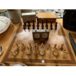A LARGE WOODEN CHESS SET WITH BOXED CHESS CLOCK