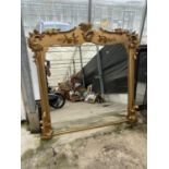 A LARGE ELABORATE GILT FRAMED MIRROR