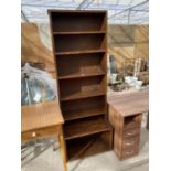 A TALL NARROW OAK BOOKCASE