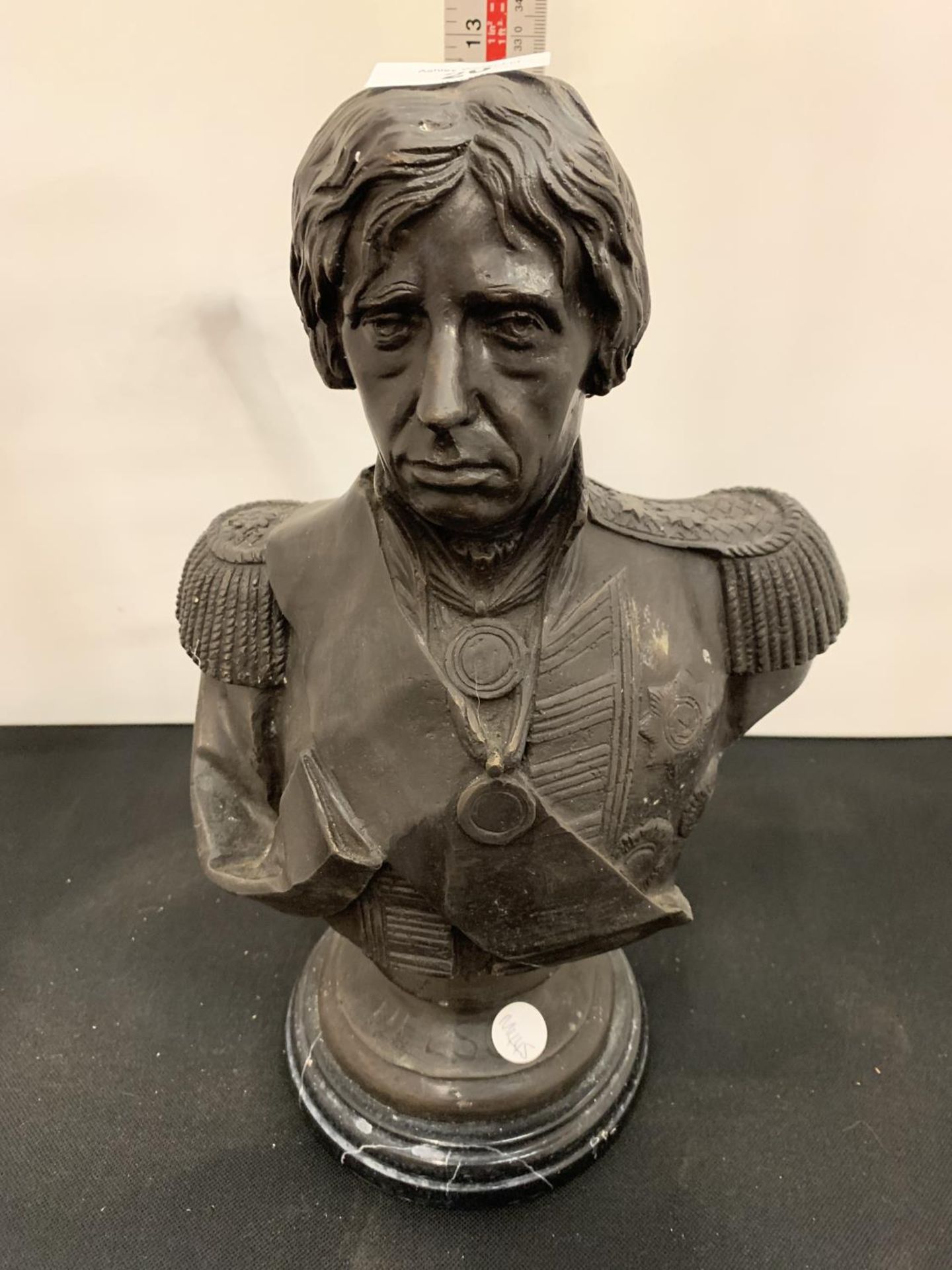 A BRONZE BUST OF NELSON ON A MARBLE BASE