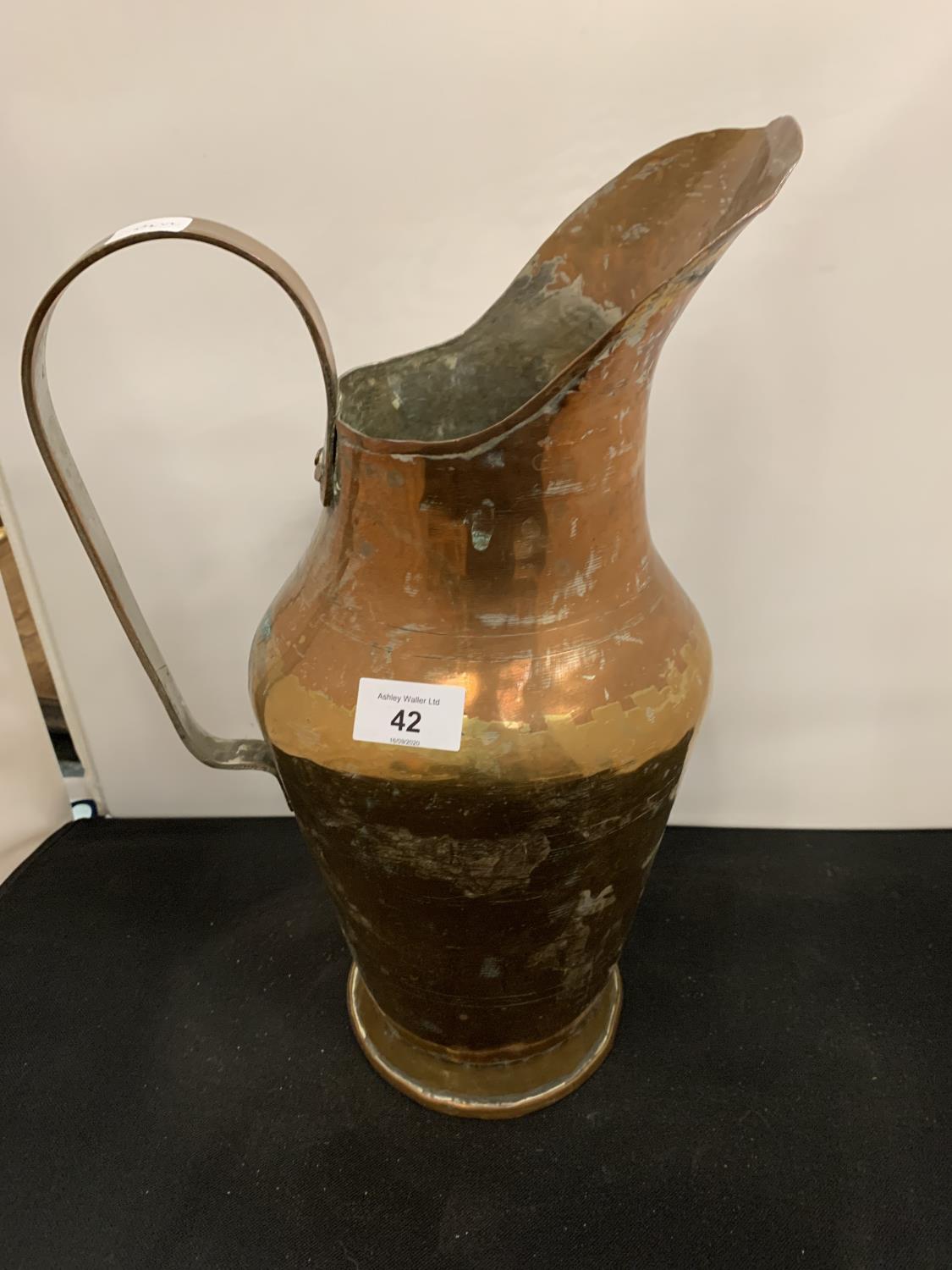 A LARGE COPPER JUG