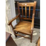 AN OAK CARVER ARMCHAIR WITH SOLID SEAT