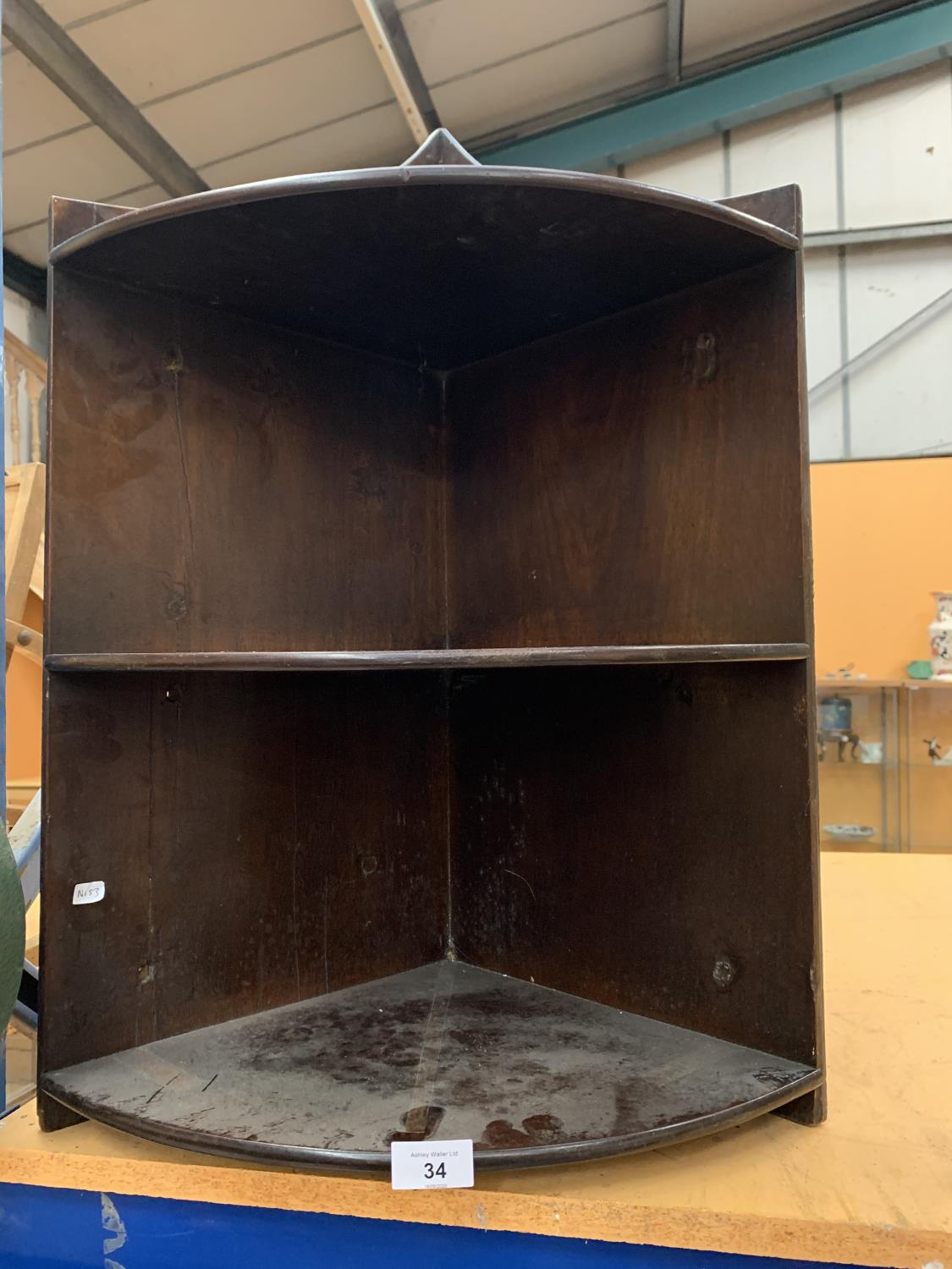 A MAHOGANY TWO SHELF CORNER WALL SHELF