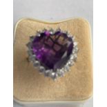 A SILVER MARKED LARGE HEART SHAPED AMETHYST AND PASTE STONE CLUSTER RING SIZE R.5