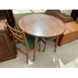 A MODERN CIRCULAR KITCHEN TABLE AND TWO CHAIRS