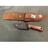 A LEATHER CASED HUNTING KNIFE WUTH BLADE PROTECTOR