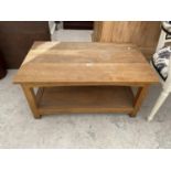 AN OAK COFFEE TABLE WITH LOWER SHELF