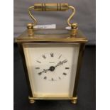 A BRASS FRENCH CARRIAGE CLOCK WITH KEY
