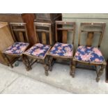 A SET OF FOUR EARLY 20TH CENTURY OAK DINING CHAIRS