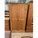 A MODERN PINE TWO DRAWER WARDROBE