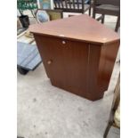 A TEAK CORNER CABINET