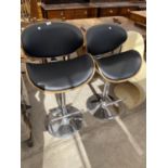A APIR OF CHROME AND BENTWOOD ADJUSTABLE BAR STOOLS IN EAMES STYLE