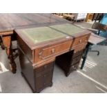 A REPRODUCTION TWIN PEDESTAL DESK COMPLETE WITH INSET LEATHER TOP