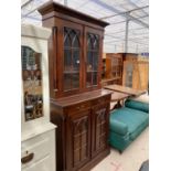 A VICTORIAN STYLE TWO DOOR BOOKCASE ON BASE OF TWO CUPBOARDS AND TWO DRAWERS