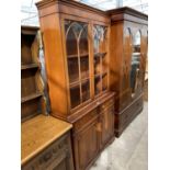 A MAHOGANY CABINET WITH TWO DOORS, TWO DRAWERS AND TWO UPPER GLAZED DOORS