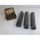 THREE MACHINE GUN MAGAZINES AND A CASED GUN CLEANING KIT