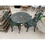 A VINTAGE HEAVY CAST IRON GARDEN TABLE AND TWO MATCHING CHAIRS