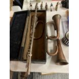 A BUFFET FLUTE AND THREE BUGLE PARTS IN A WOODEN CASE