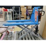 A HIGH LIFT PALLET TRUCK (REQUIRES ATTENTION}