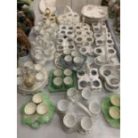 A LARGE COLLECTION OF CERAMIC EGG CUPS AND HOLDERS