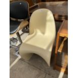 A VINTAGE S SHAPED LOW CHAIR IN MOULDED PLASTIC