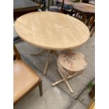 A MODERN CIRCULAR DINING TABLE AND SMALL STOOL