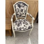 A CREAM AND FLORAL UPHOLSTERED ARMCHAIR