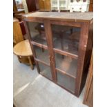 AN OAK TWO DOOR GLAZED BOOKCASE, TOP 37" WIDE