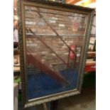 A LARGE GILT FRAMED MIRROR WITH ETCHED DETAIL