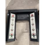 A CAST IRON FIREPLACE WITH FLORAL TILE DECORATION
