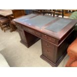 A MAHOGANY TWIN PEDESTAL DESK WITH ONE DOOR, SIX DRAWERS AND INSET LEATHER TOP