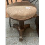 A VICTORIAN WALNUT ROTATING PIANO STOOL WITH AN UPHOLSTERED SEAT