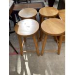 A SET OF FOUR BEECH STOOLS