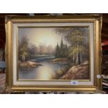 A GILT FRAMED PRINT OF A RIVER IN A FOREST