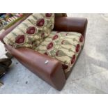 A TAN LEATHER ARMCHAIR