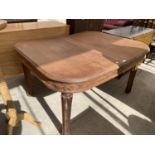 A MAHOGANY EXTENDING DINING TABLE ON FLUTED LEGS