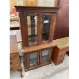 A VICTORIAN WALNUT GLAZED TWO DOOR BOOKCASE ON BASE WITH BEVELLED GLASS, 32" WIDE