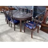 A HEAVILY CARVED ORIENTAL STYLE MAHOGANY DINING TABLE WITH SIX MATCHING CHAIRS AND TWO CARVERS