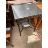 AN ARTS & CRAFTS BLACK AND GILT PAINTED TWO TIER OCCASIONAL TABLE