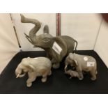 A LARGE BRASS ELEPHANT AND TWO SMALLER WOODEN ELEPHANTS