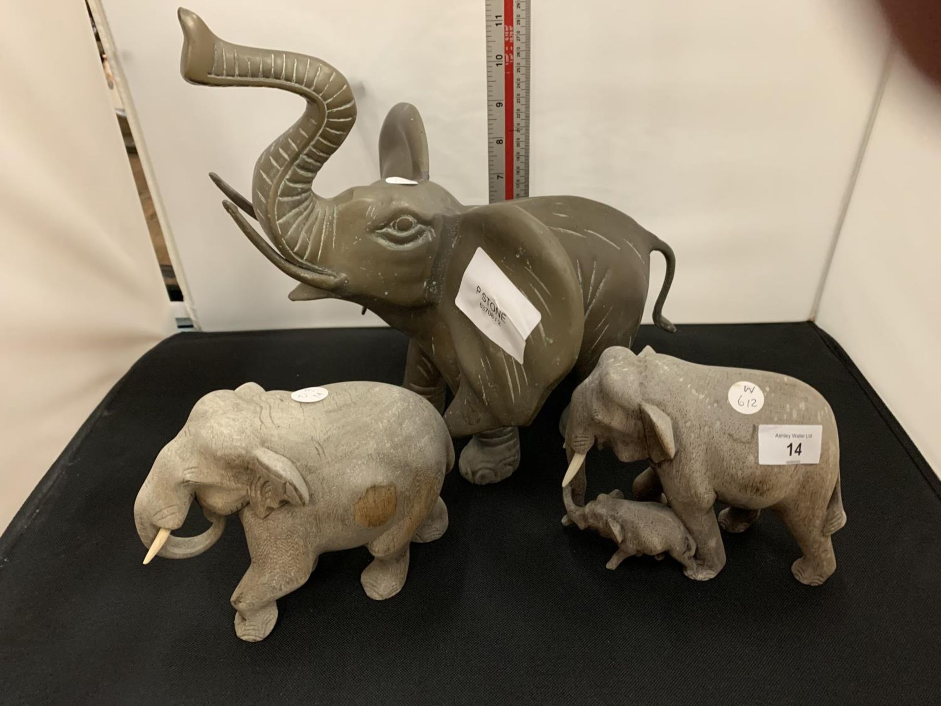 A LARGE BRASS ELEPHANT AND TWO SMALLER WOODEN ELEPHANTS