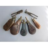 FIVE COPPER AND BRASS POWDER FLASKS AND TWO BULLET MOULDS