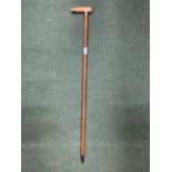 A WALKING STICK WITH A BONE HANDLE AND A POSSIBLY SILVER FINIAL