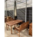 A RECTANGULAR TEAK GARDEN TABLE WITH TWO MATCHING BENCH SEATS AND PARASOL WITH CAST ITON BASE