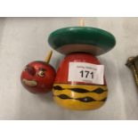A WOODEN SPINNING TOP IN THE SHAPE OF A CLOWN