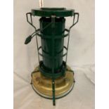 A BRASS AND GREEN PAINTED ALADDIN PINK PARAFFIN STOVE