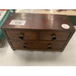 AN APPRENTICE MINIATURE CHEST OF DRAWERS WITH JEWELLED HANDLES